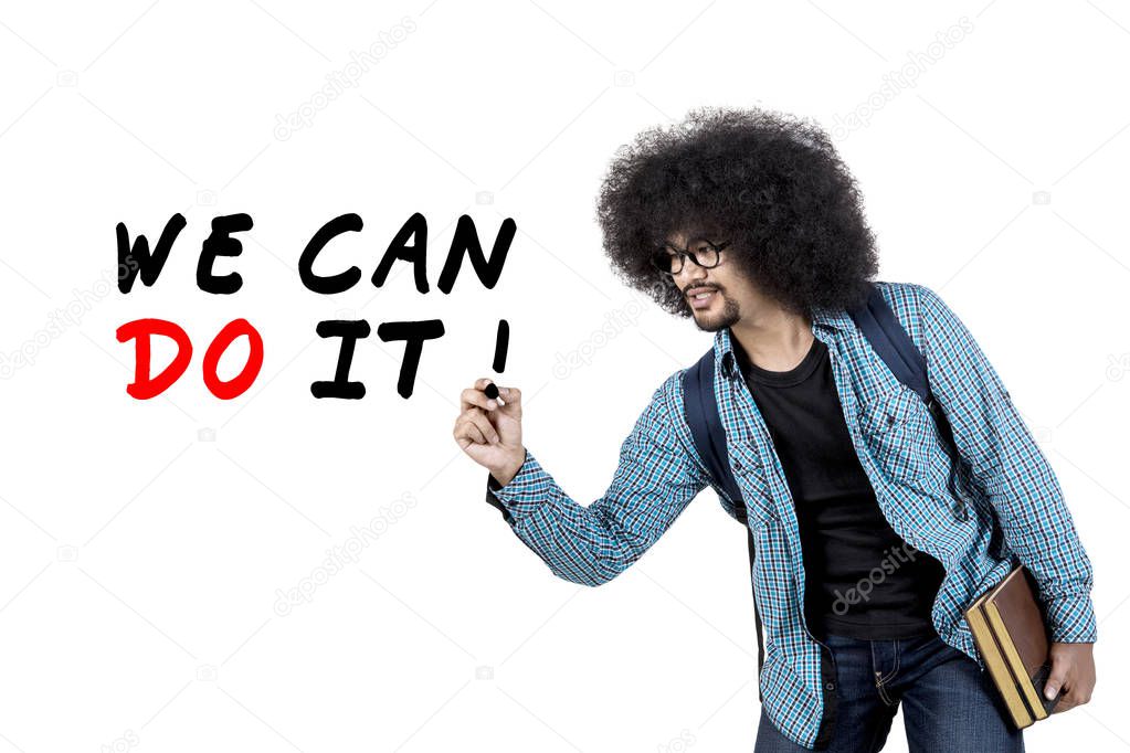 Afro guy writing we can do it text on screen