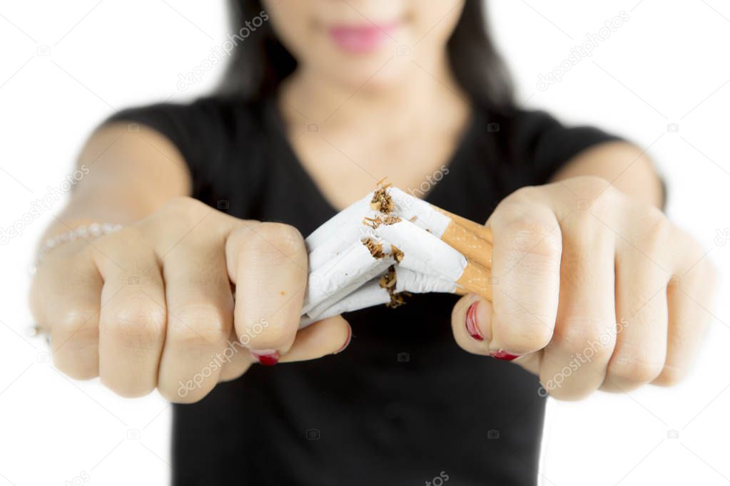Female hand destroying cigarettes 