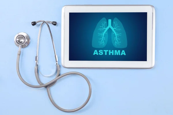 Stethoscope and tablet on the blue background — Stock Photo, Image