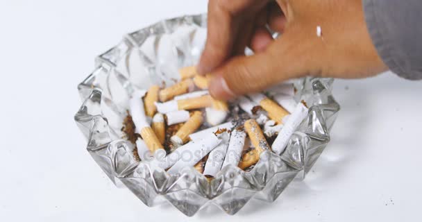 Hand putting out cigarette on ashtray — Stock Video