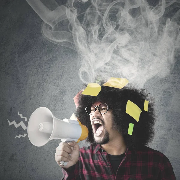 Angry Afro man screaming with megaphone — Stock Photo, Image
