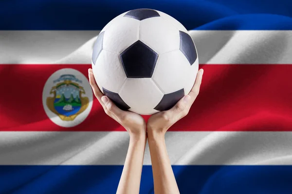Bola en las manos con bandera de Costa Rica —  Fotos de Stock