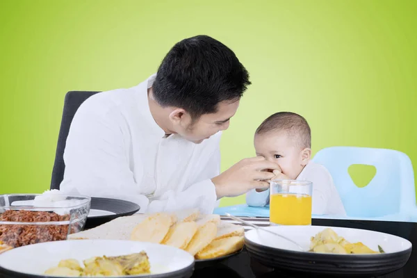 Homem alimentando seu bebê com a mão — Fotografia de Stock