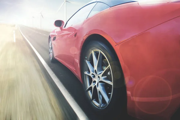 Red car is moving fast on the road — Stock Photo, Image