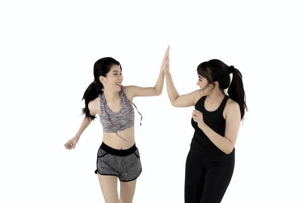 Two women giving high five in studio — Stock Photo, Image