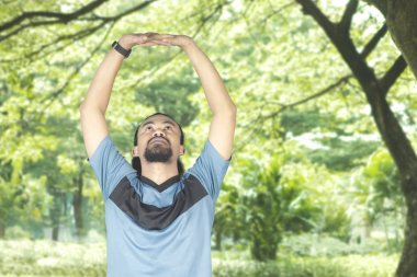 Afro adam kollarını Park'ta germe