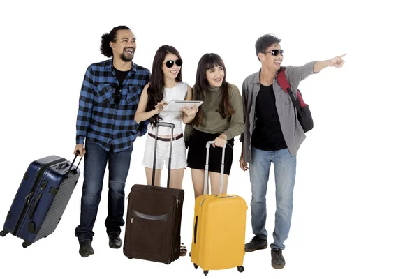 Diverse tourist with suitcase and tablet on studio — Stock Photo, Image