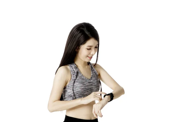 Pretty female with smartwatch on studio — Stock Photo, Image