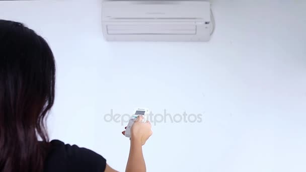 Woman turn on the air conditioner — Stock Footage Woman turn on the air conditioner Video Clip