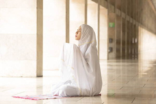 Muslim woman praying for Allah, muslim god 