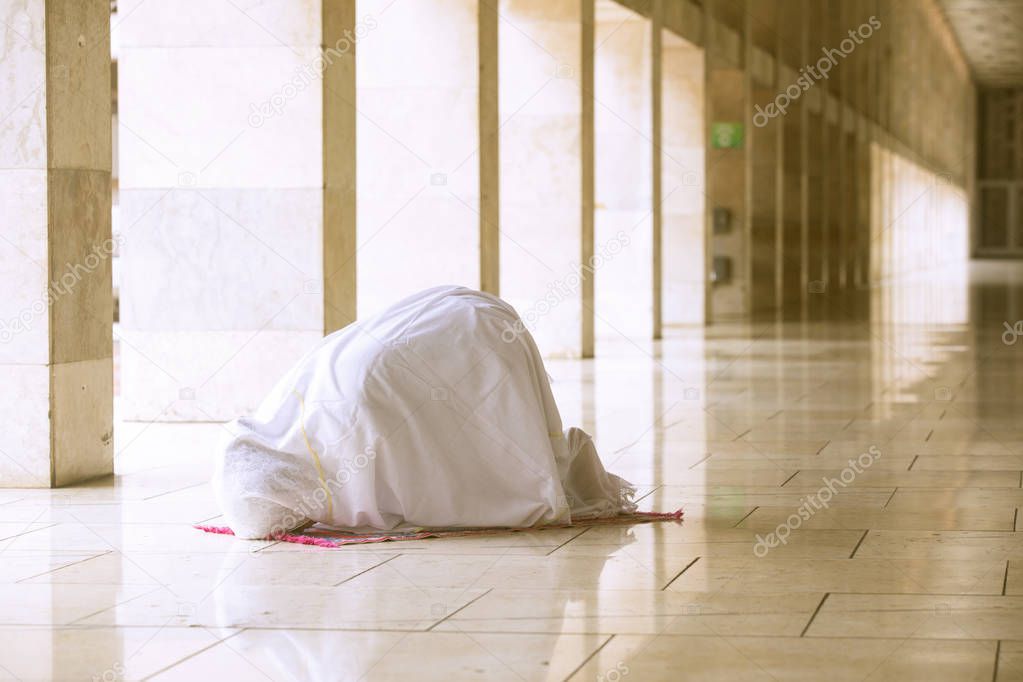 Woman doing prostration in mosque 