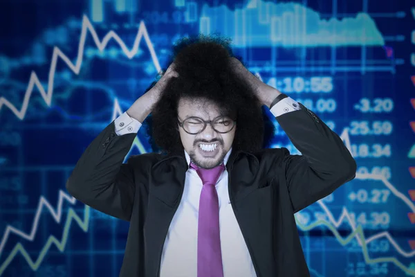 Afro businessman with declining financial graph — Stock Photo, Image