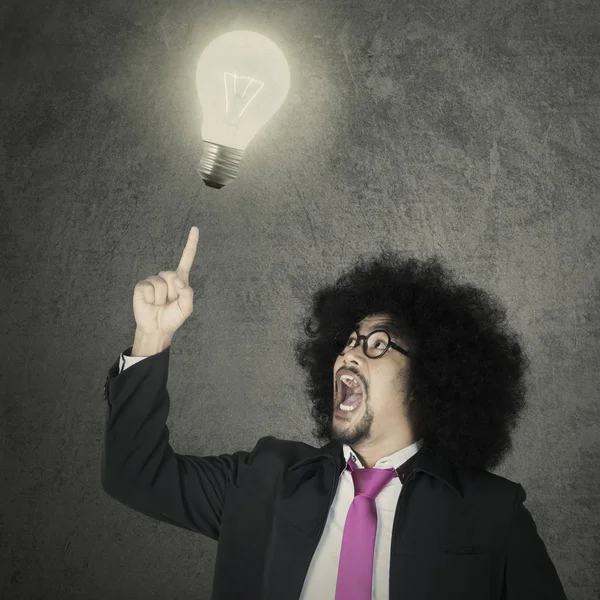 Afro male entrepreneur and light bulb — Stock Photo, Image