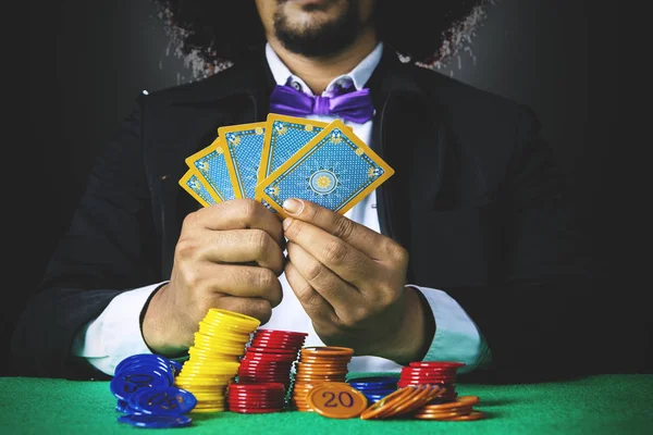 Afro man holds poker cards — Stock Photo, Image