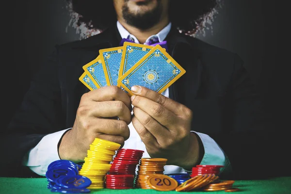 Man playing poker cards in gambling — Stock Photo, Image