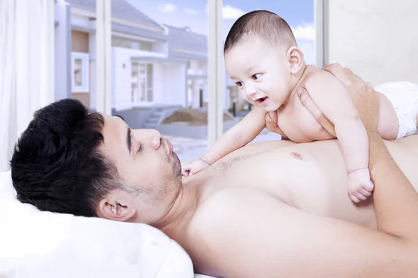 Adorable baby smiling at his father — Stock Photo, Image