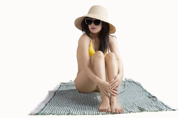 Beautiful woman sitting on mat — Stock Photo, Image