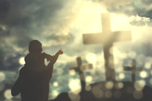 Father and child looking at three crucifixes — Stock Photo, Image