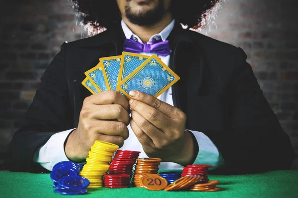 Gambler with cards and chip — Stock Photo, Image