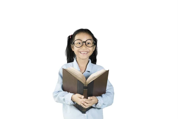 Smiling schoolgirl holding textbook — Stock Photo, Image