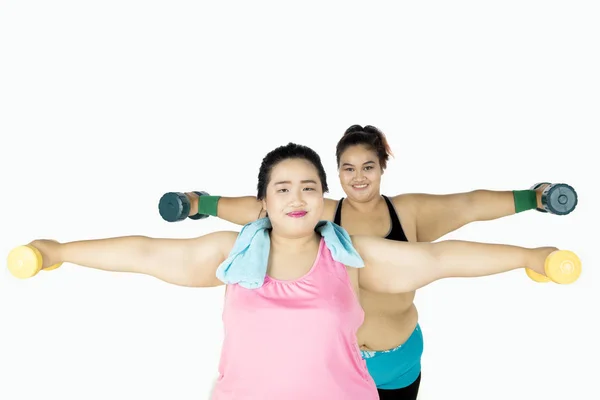 Two fat women training with dumbbells — Stock Photo, Image