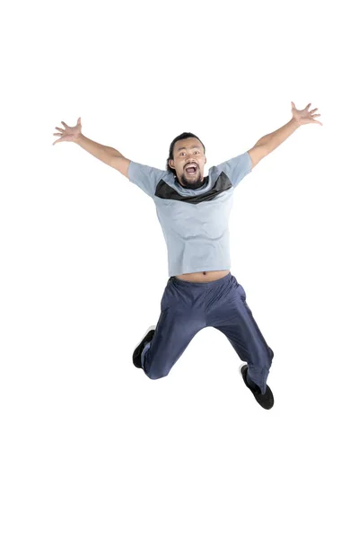 Afro man jumping in studio — Stock Photo, Image