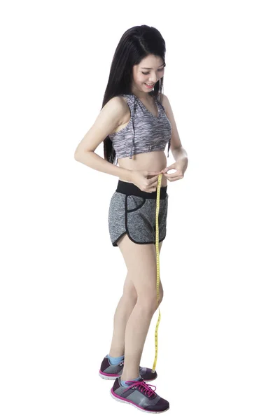 Girl measuring her slim waistline — Stock Photo, Image