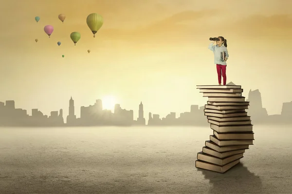 Écolière debout sur une pile de livres — Photo