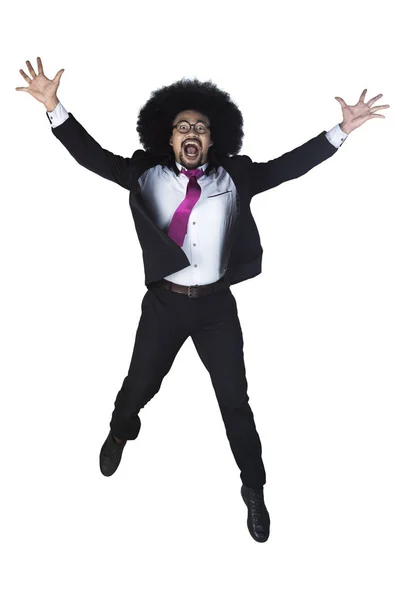 Successful businessman jumps with arms raised — Stock Photo, Image