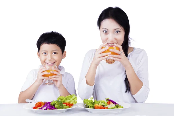 Mother and child having breakfast on studio Royalty Free Stock Images