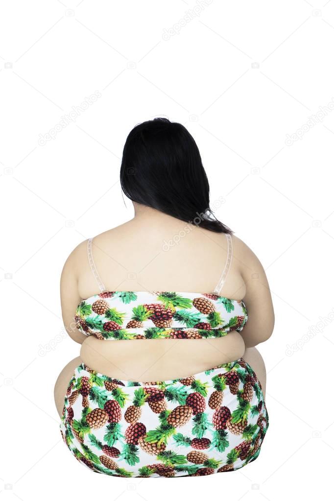 Overweight woman sitting in the studio