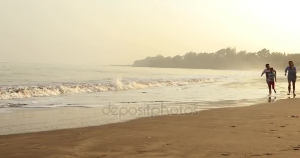 Niños y madre corriendo en la playa — Vídeos de Stock