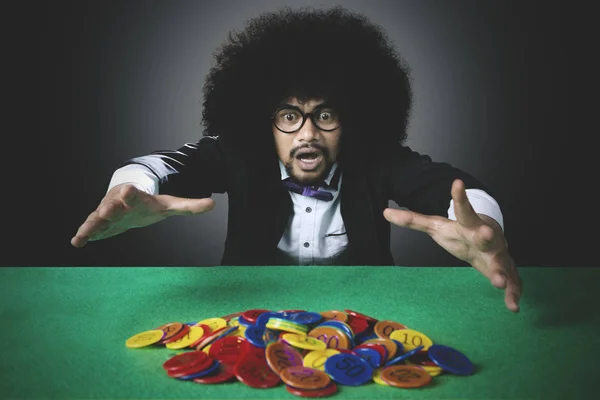 多くのカジノのチップを失うアフロの男 — ストック写真