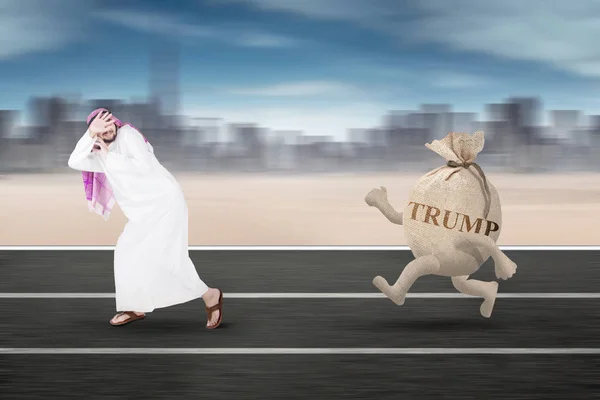 Arabian businessman is chased Trump word on track — Stock Photo, Image