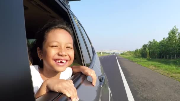 Весела беззубна дівчина дивиться з вікон автомобіля — стокове відео