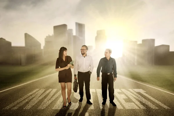 Business people walking with investment word — Stock Photo, Image