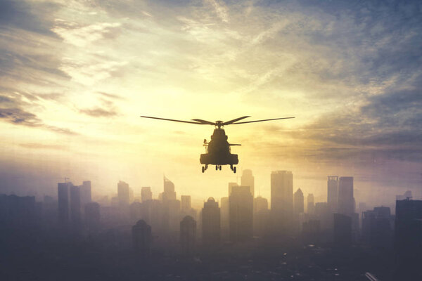 Military helicopter hovering at sunset time