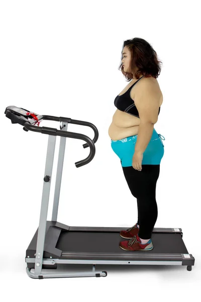 Depressed fat woman standing on the treadmill — Stock Photo, Image