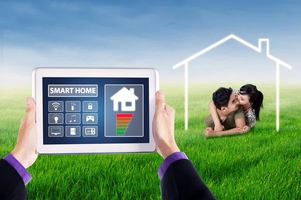 Smart home controller and young couple — Stock Photo, Image