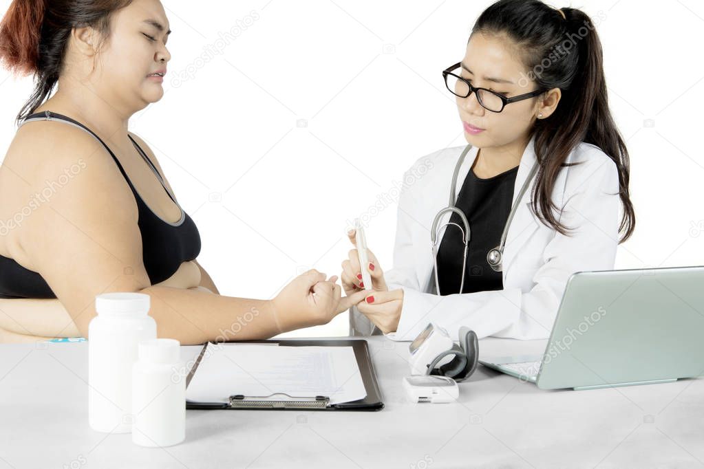 Doctor checking patient blood sugar