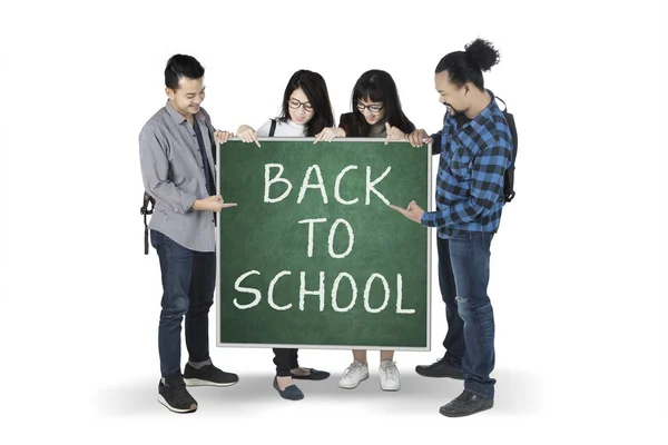 Mixed students show text of back to school — Stock Photo, Image