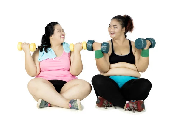 Obese people workout with dumbbells
