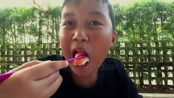 Boy eating Nigiri Sushi at restaurant — Stock Video