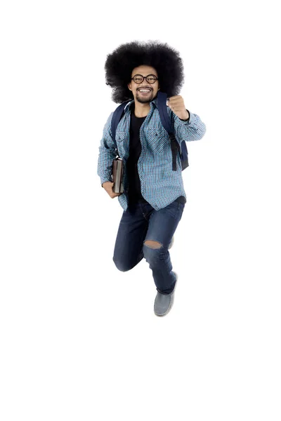 African male student jumping in the studio — Stock Photo, Image