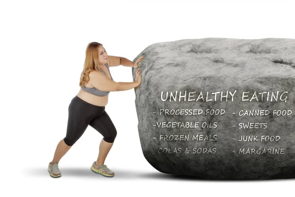 Fat woman pushing a stone with her problem