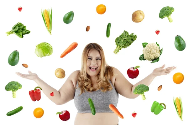 Mujer gorda feliz con frutas y verduras que caen — Foto de Stock