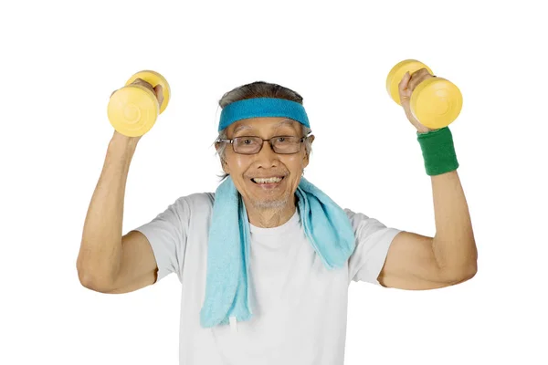 Happy old man lifting two dumbbells — Stock Photo, Image