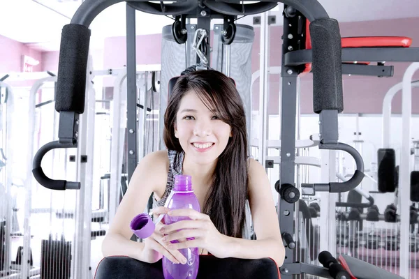 Pretty woman with bottle after exercising — Stock Photo, Image