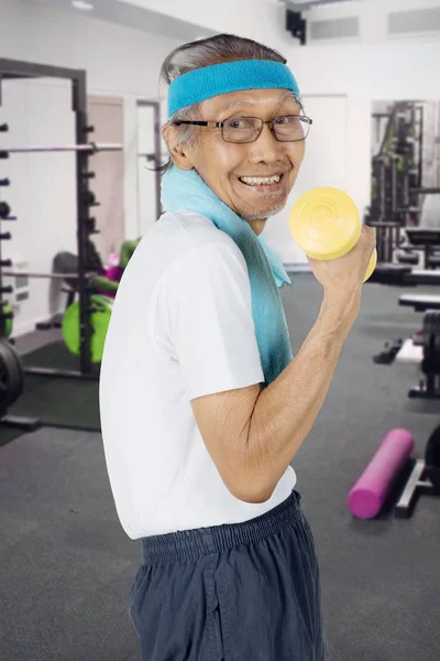 Old man exercising with a dumbbell — Stock Photo, Image