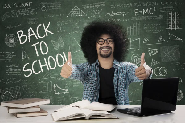 Male student giving thumbs up — Stock Photo, Image